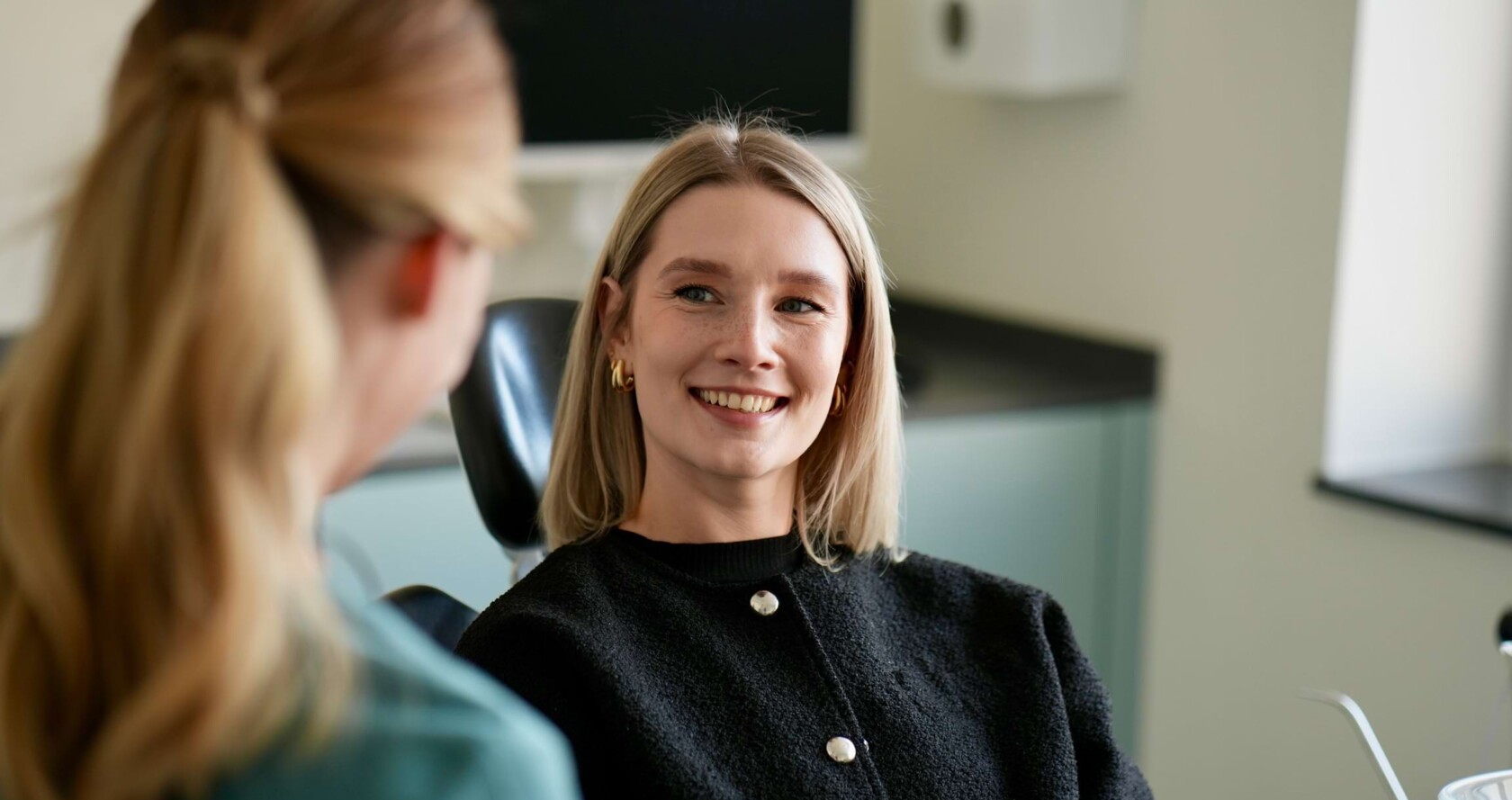 Isabell Jordan ber&auml;t eine Patientin. Frau Jordan ist von hinten zu erkennen und der Fokus ist auf der Patientin.